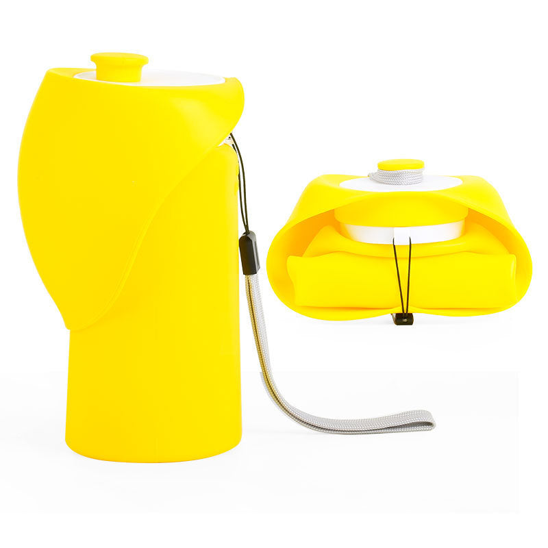 Foldable pet water bottle with squeeze dispensing in Light Grey, in a home setting
