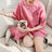 Small dog wearing a striped cotton T-shirt in blue
