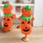 Cat dressed in a funny pumpkin head Halloween costume