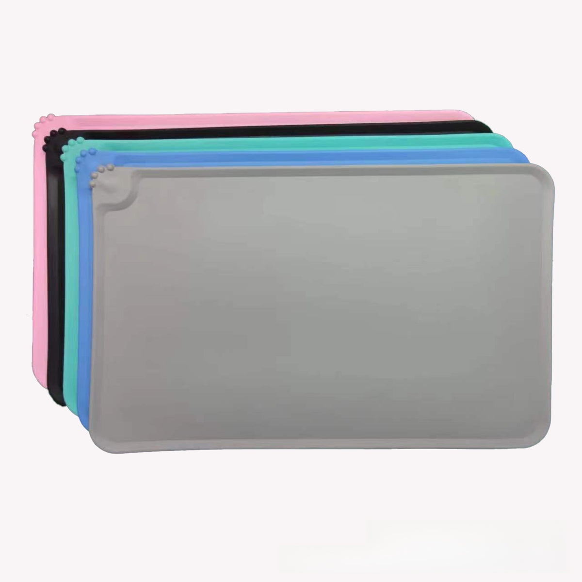 Pink waterproof silicone mat placed under cat food bowls