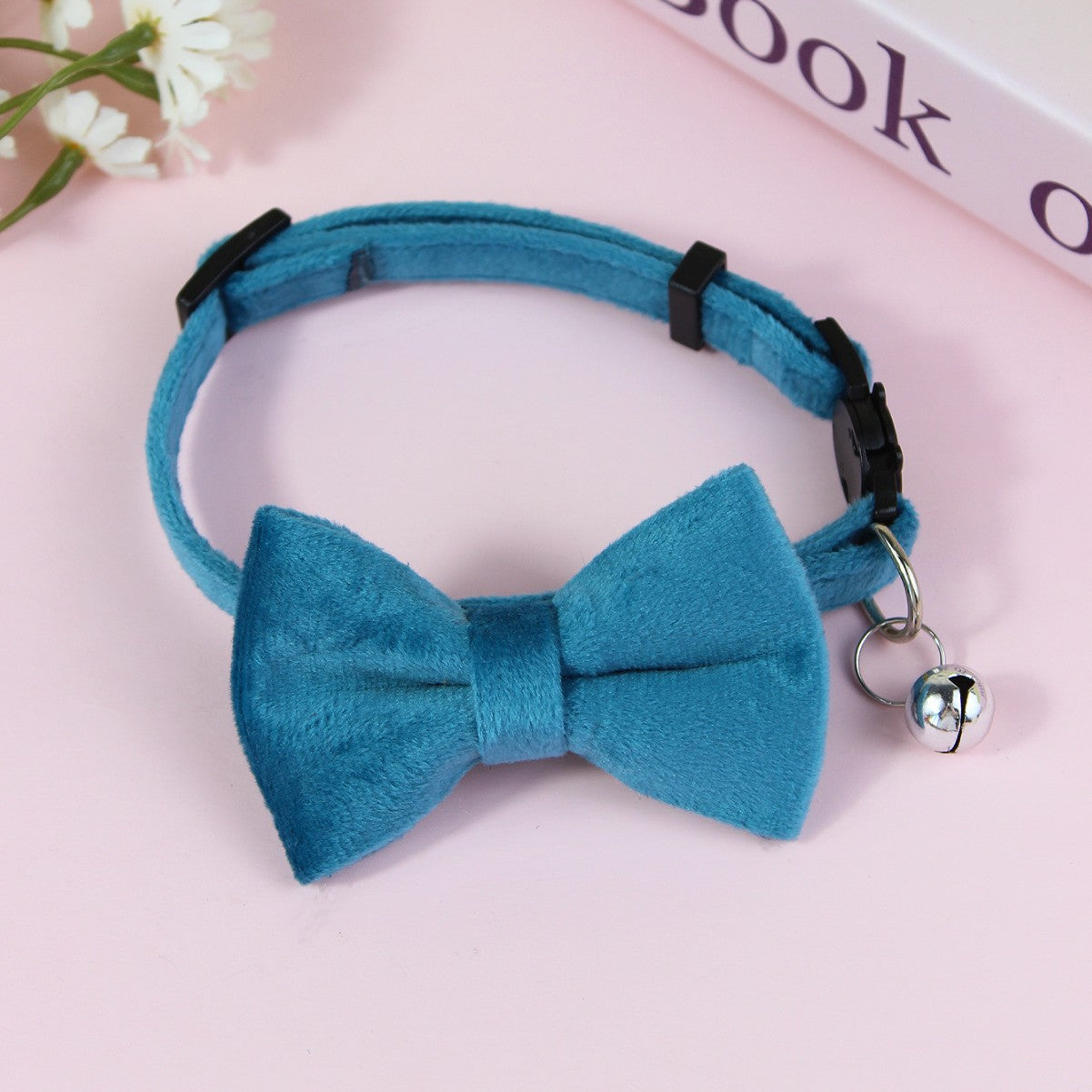 Striped cat collar with velvet bow, close-up detail view