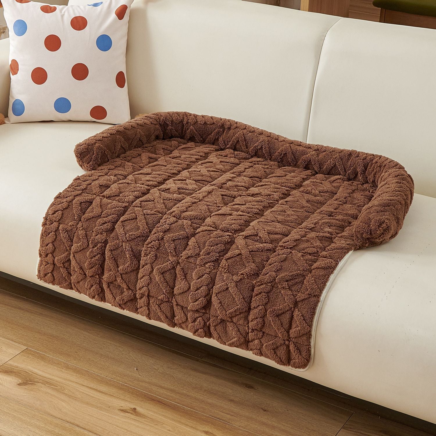 Cat resting in a grey fluffy nest pet bed