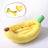 Kitten sleeping in a yellow banana cat bed with heart bone pillow