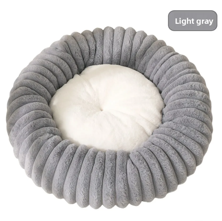Small dog curled up in a khaki striped faux fur bed