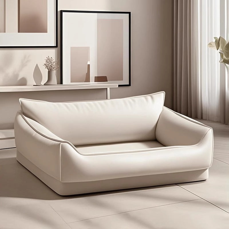 Small dog sitting on a 55 by 45cm faux leather sofa bed
