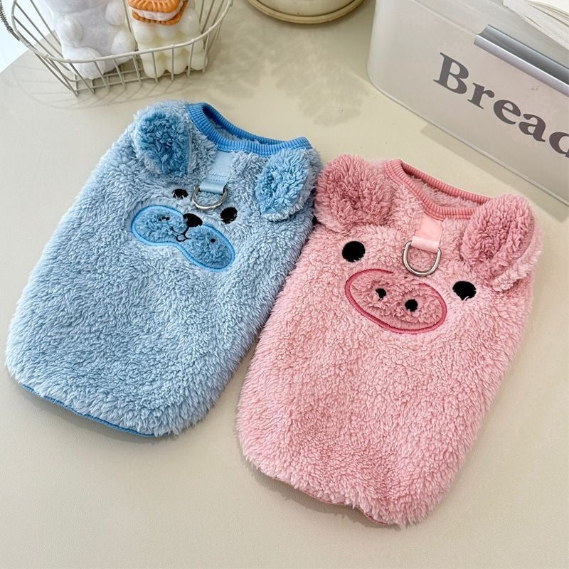 Small dog in a pink fleece lined jumper with piglet embroidery
