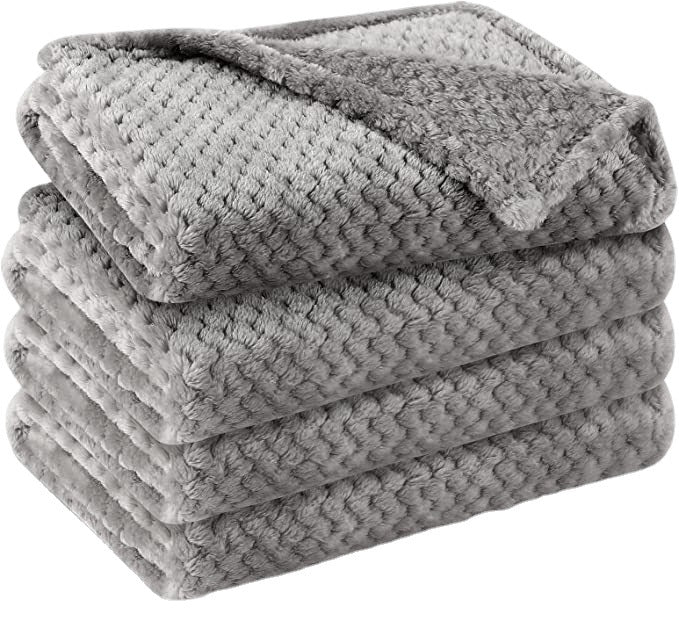 Dusty pink soft pet throw on a sofa