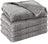 Dusty pink soft pet throw on a sofa
