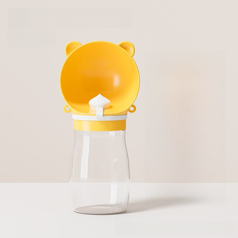 Portable dog water bottle in food-grade ABS, in use with a pet
