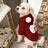Small dog in a Christmas snowman faux lambswool jacket