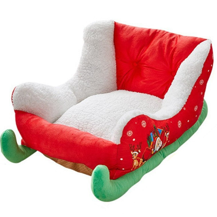 Small dog sleeping in a festive sleigh pet bed for winter