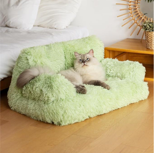 Small dog sleeping on a peach pink velvet pet sofa bed