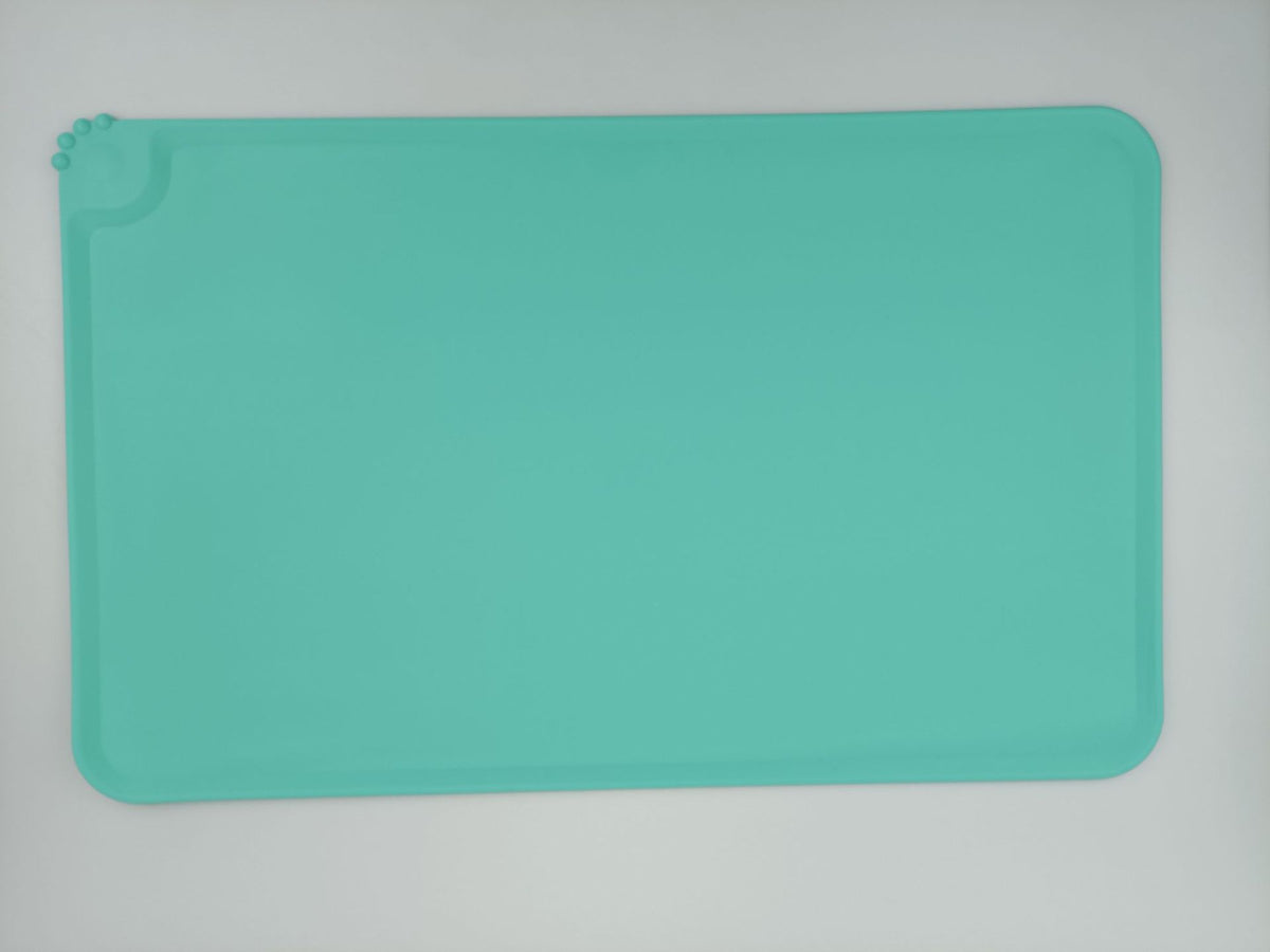 Pink waterproof silicone mat placed under cat food bowls