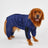 Reflective hooded dog raincoat in silver fabric, in a home setting