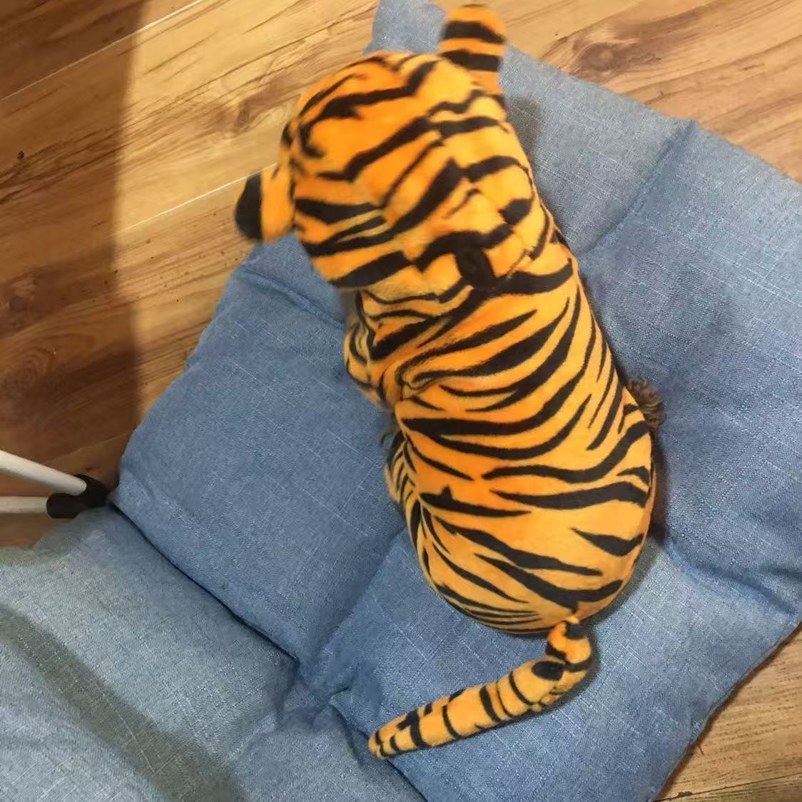 Small dog dressed as a cute yellow tiger