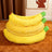 Banana shaped plush pet bed with cat curled inside, photo 4