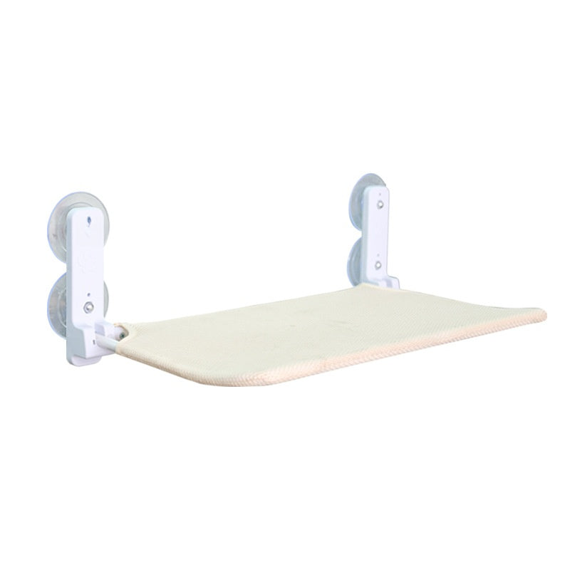 Cat lounging in a grey breathable window hammock