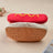 Small dog dressed in a funny frankfurter jacket costume
