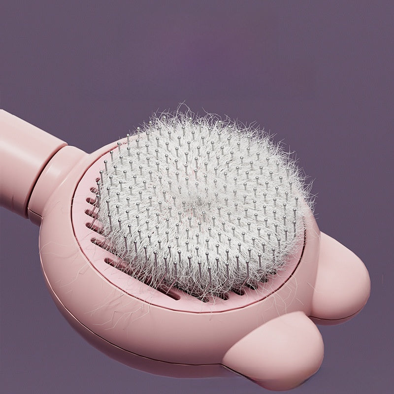 Light blue deshedding comb lifting fur from a cat