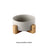 Ceramic cat bowl on a raised wooden stand in white
