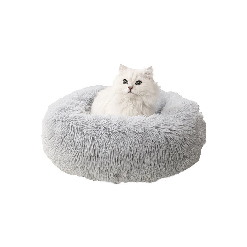 Cat sleeping in a pink USB warming nest