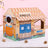 Cat scratching inside a themed cardboard scratcher house