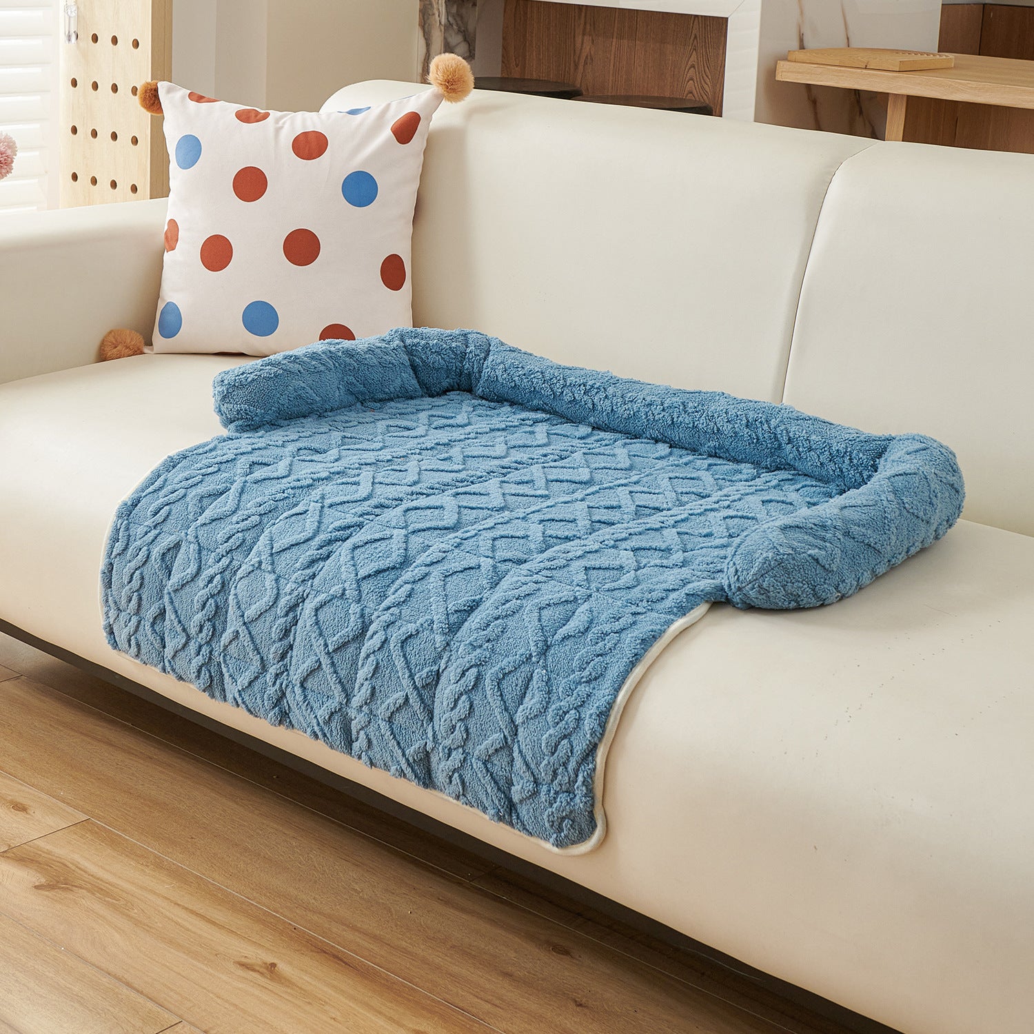 Cat resting in a grey fluffy nest pet bed