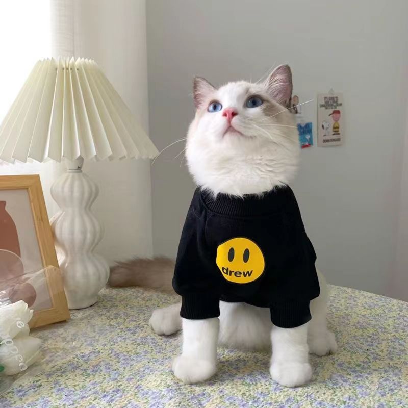 Smiley face cotton cat jumper in Red Smiley, in a home setting