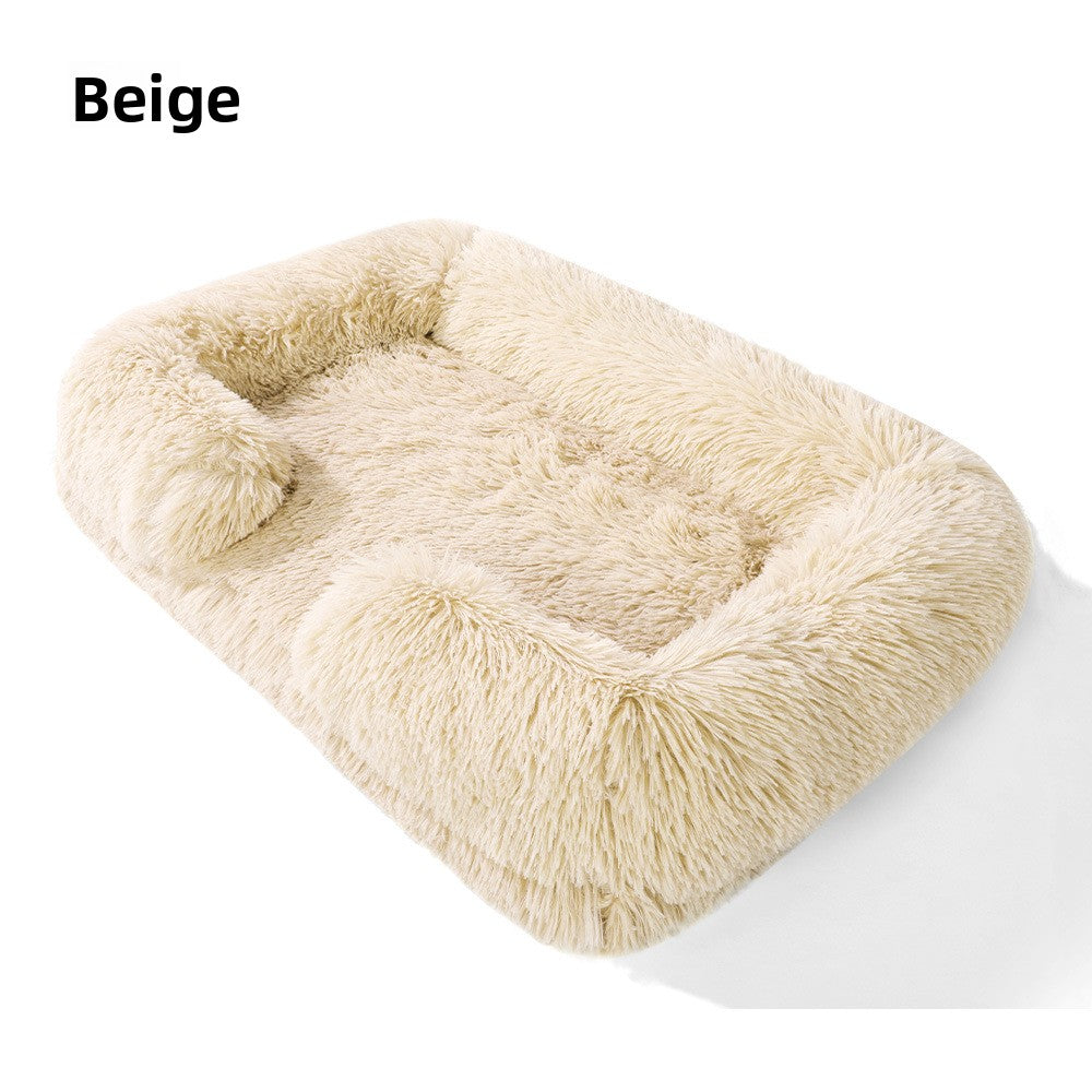 Dog sleeping in a pink square plush bed with cushion