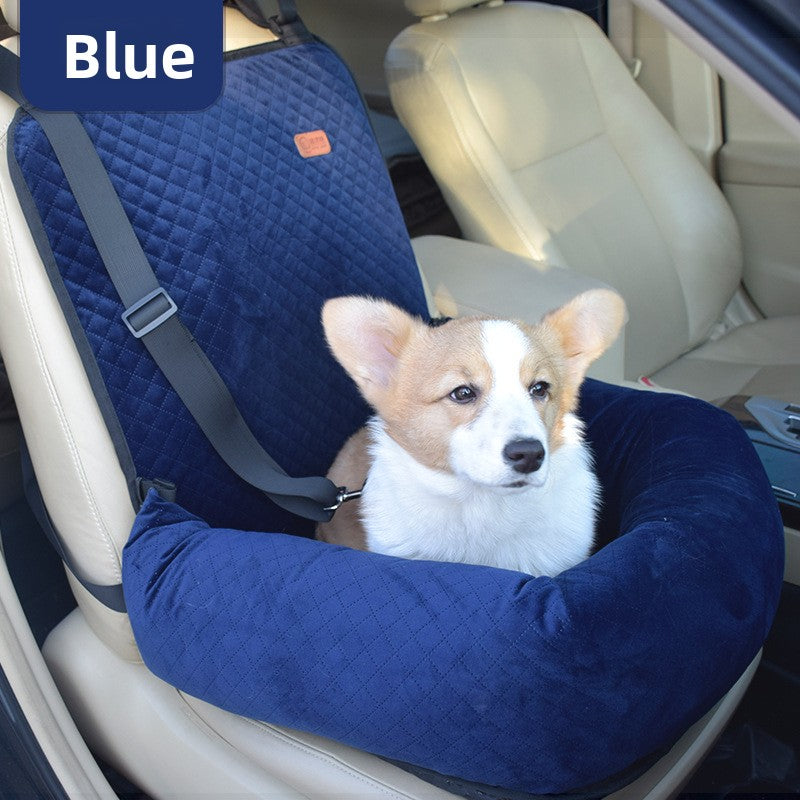 Small dog travelling in a grey plaid car seat bed