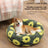 Plush round pet bed in check and floral prints, close-up detail view