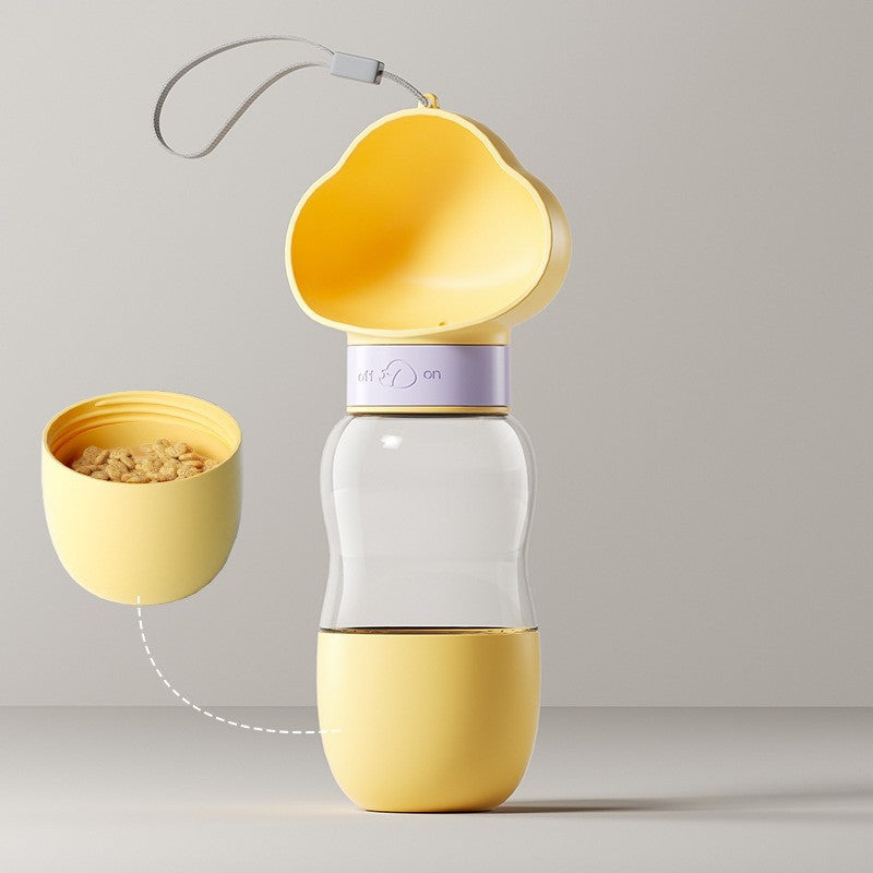 Portable pet water bottle and food container, in use with a pet