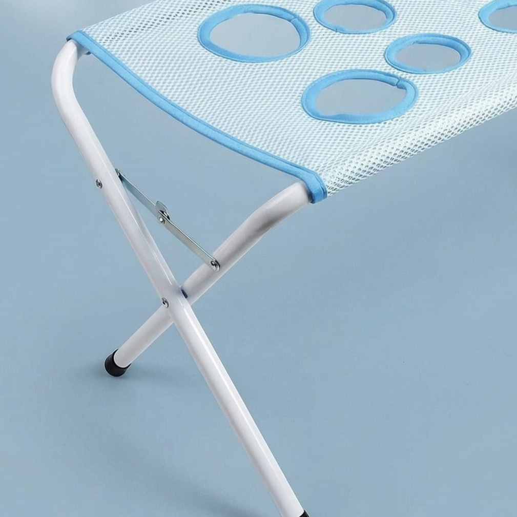 Dog standing in a stainless steel bathing support frame