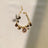 Faux pearl necklace collar with bell in Pink, in a home setting