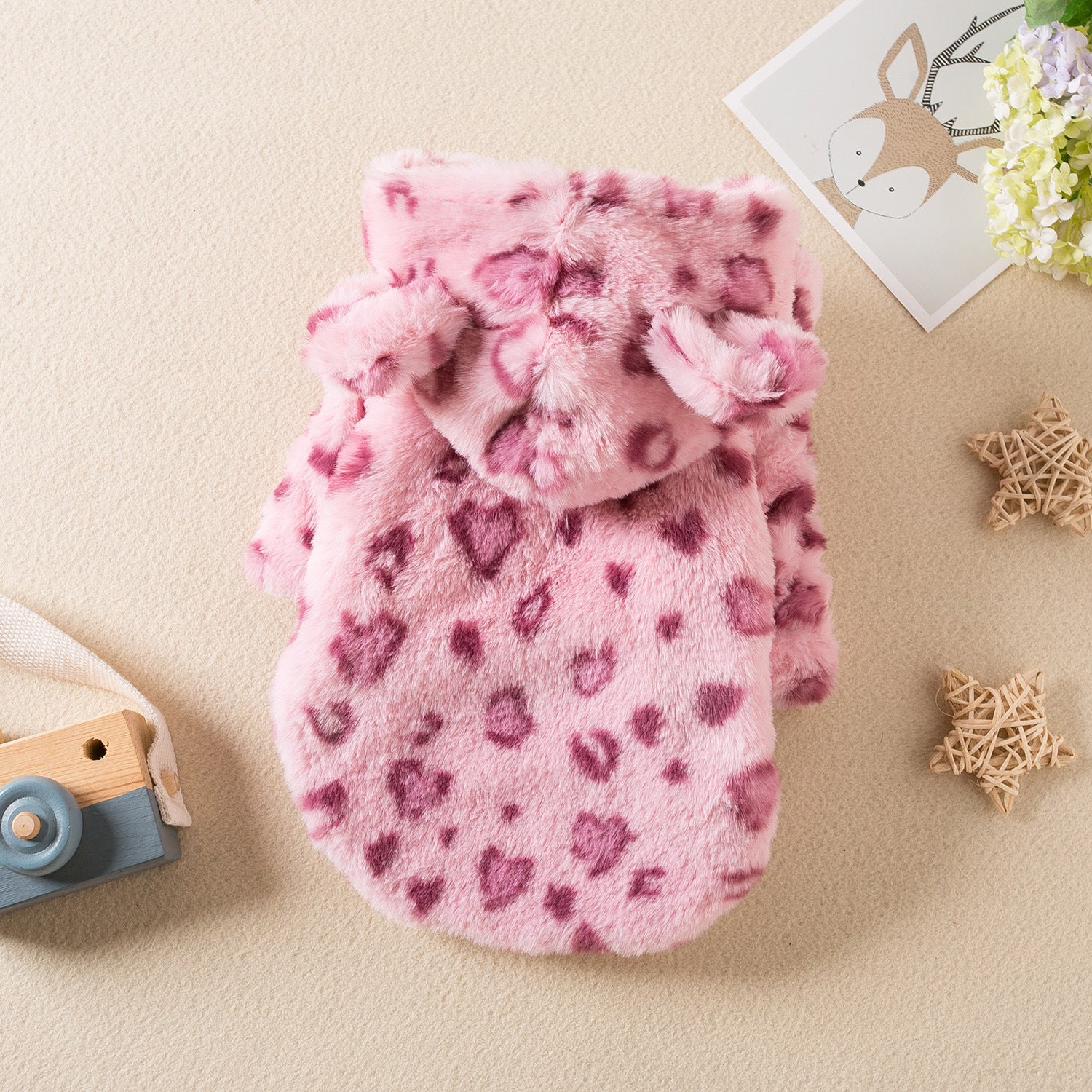 Small dog wearing a pink leopard print plush hoodie