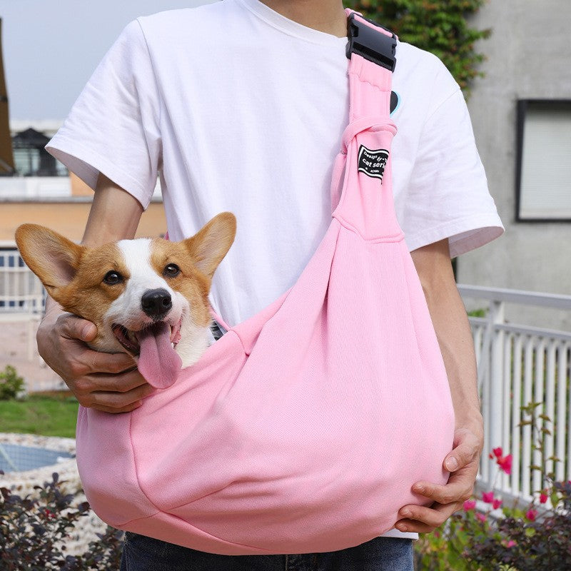 Foldable grey pet shoulder carrier bag with a small dog inside, view 1