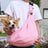 Foldable grey pet shoulder carrier bag with a small dog inside, view 1