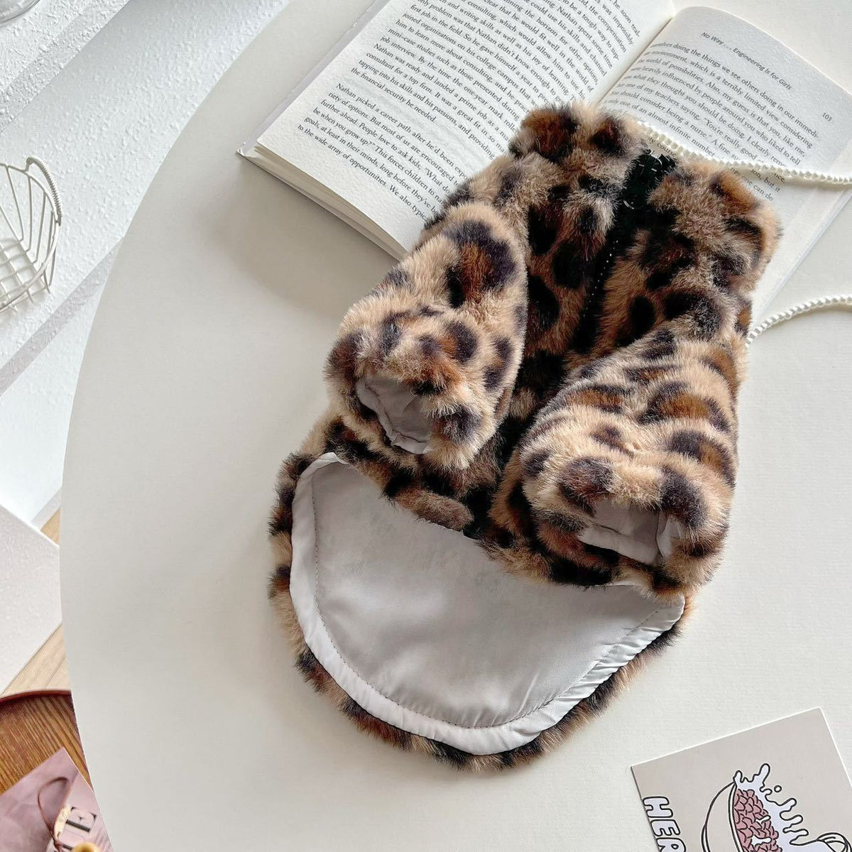 Small dog wearing a pink leopard print plush hoodie