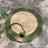 Round woven cattail grass cat scratch mat in Olive Green, size 50cm Diameter