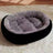 Cat lying in a pink wool blend oval pet bed