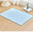 Dog resting on a light green cooling pad