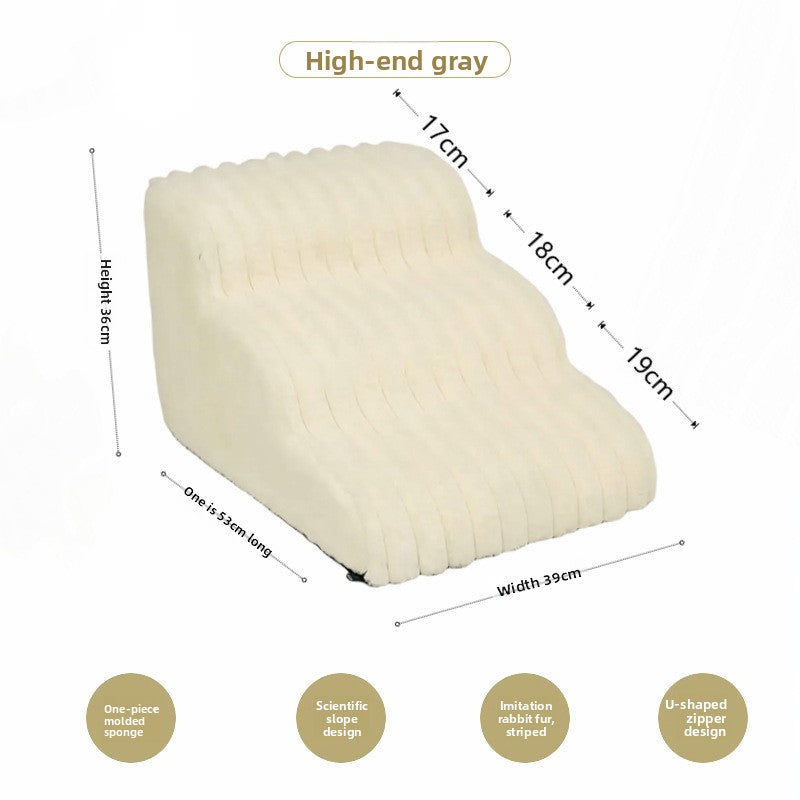 Small dog climbing off white washable dog stairs