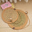 Round woven cattail grass cat scratch mat, shown in 4 colours and styles