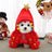 Small dog wearing a green plush Christmas tree cape