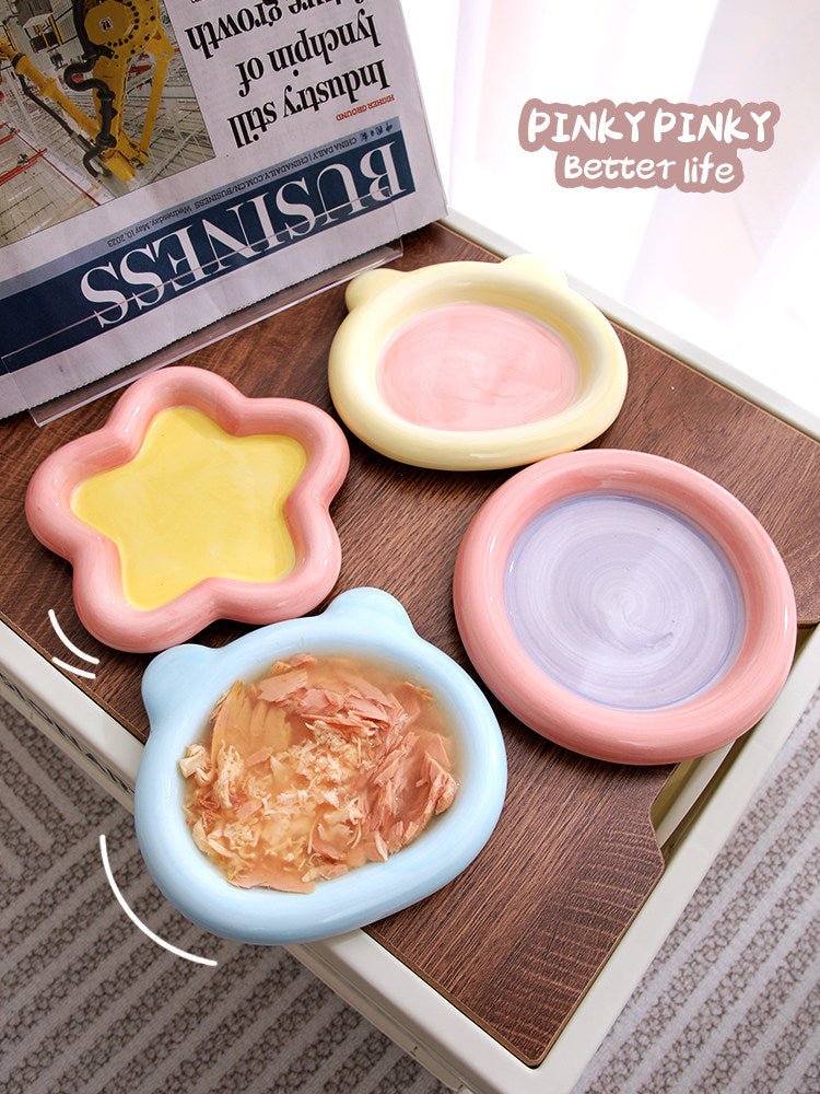 Shallow ceramic pet food plate with cute bear design in blue and pink, view 1
