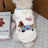 Small dog wearing a pink thick fleece cartoon vest