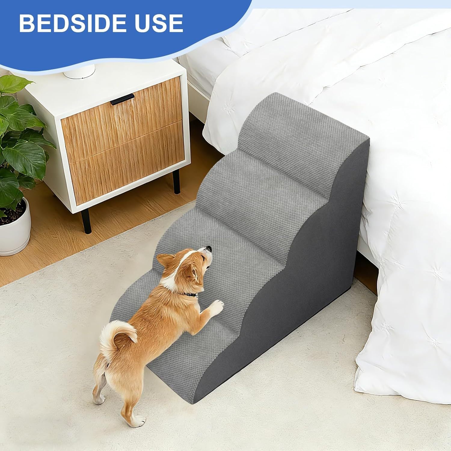 Grey foam pet stairs placed at the side of a bed for a small dog