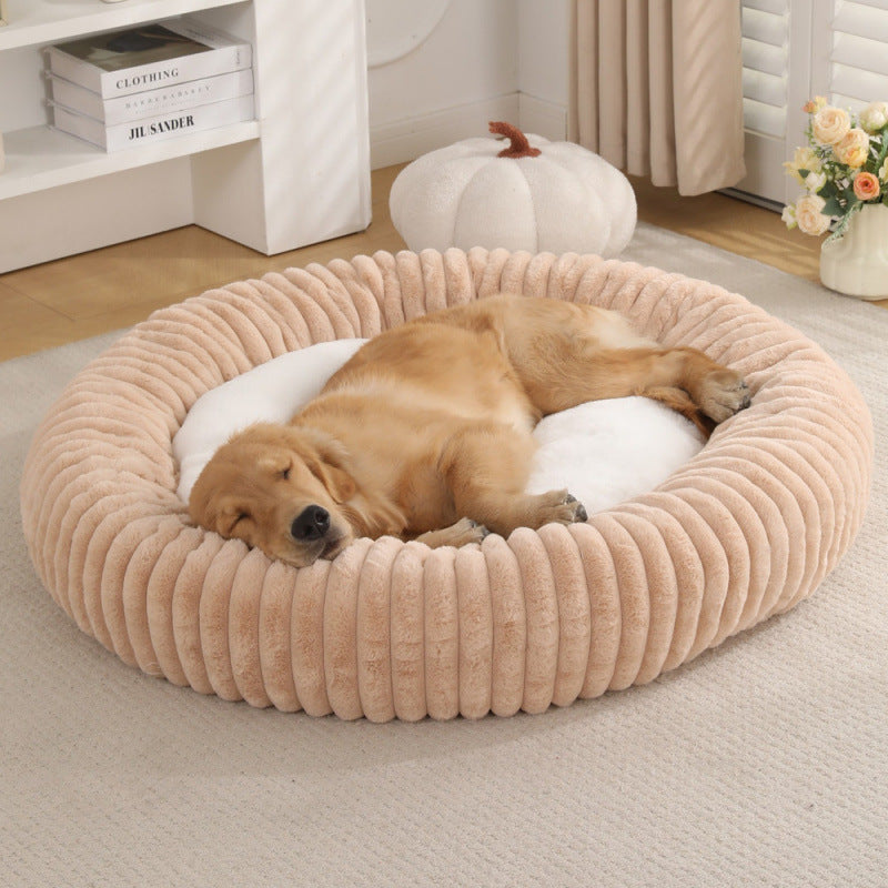 Small dog curled up in a khaki striped faux fur bed