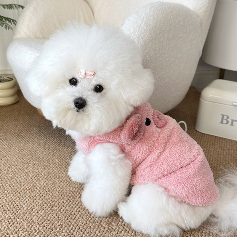 Small dog in a pink fleece lined jumper with piglet embroidery