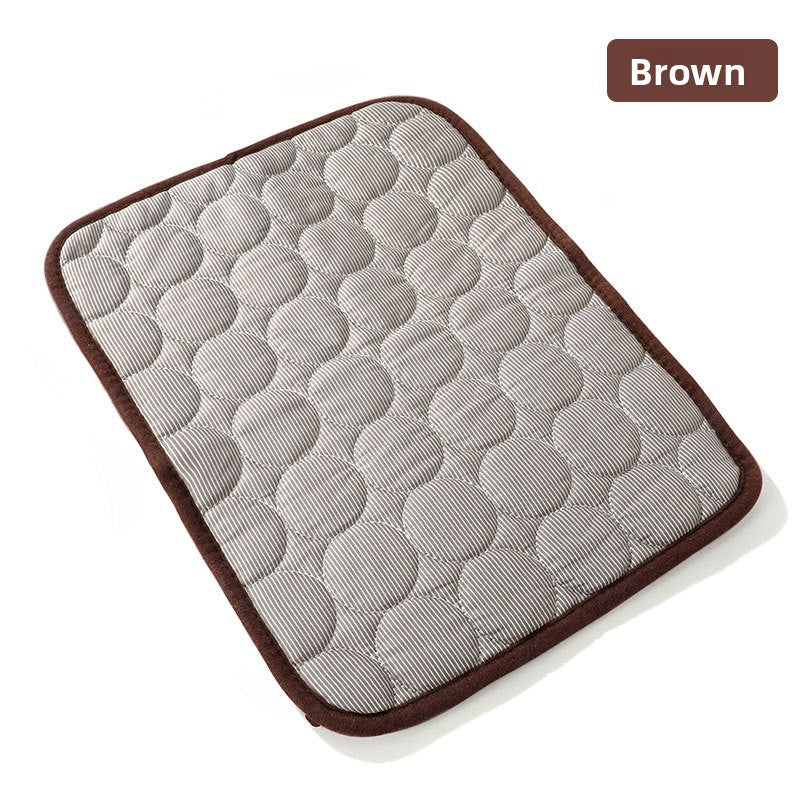 Dog lying on a large grey ice silk mat
